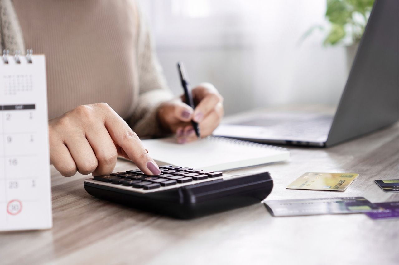 Pessoa calculando parcelas de empréstimo pessoal 2026, analisando taxas de juros e planejamento financeiro antes de contratar crédito online